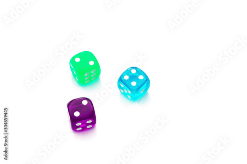 green, blue, violet dice's with different number on the sides on white background