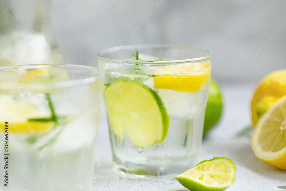 Lime and lemon mojito cocktails, fresh summer drink with ice and rosemary Lime and lemon mojito cocktails, fresh summer drink with ice and rosemary