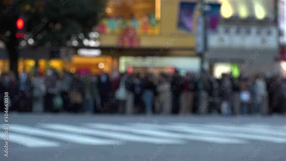 SHIBUYA, TOKYO, JAPAN - NOVEMBER 2019 : Crowd of people at Shibuya Scramble Crossing in busy early evening rush hour. Many commuters and tourists at the street. Shot in sunset time. In front focus. SHIBUYA, TOKYO, JAPAN - NOVEMBER 2019 : Crowd of people at Shibuya Scramble Crossing in busy early evening rush hour. Many commuters and tourists at the street. Shot in sunset time. In front focus.