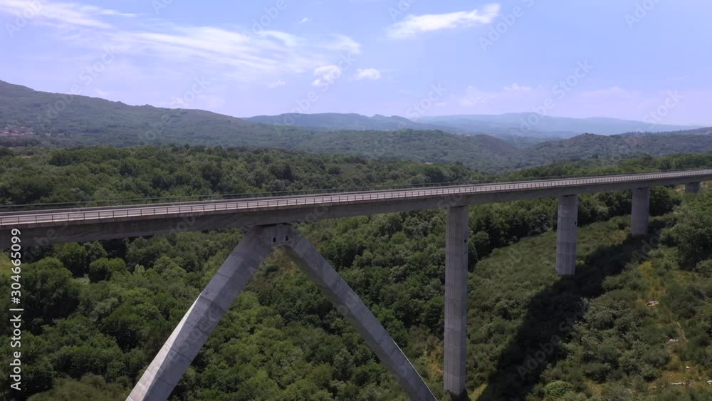 Aerial of a long bridge in the middle of the mountains, Spain. DOLLY LEFT Aerial of a long bridge in the middle of the mountains, Spain. DOLLY LEFT