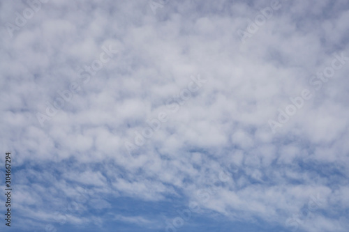 Fototapeta Naklejka Na Ścianę i Meble -  Up ward view, wave of softy and white fluffy clouds under deep blue sky