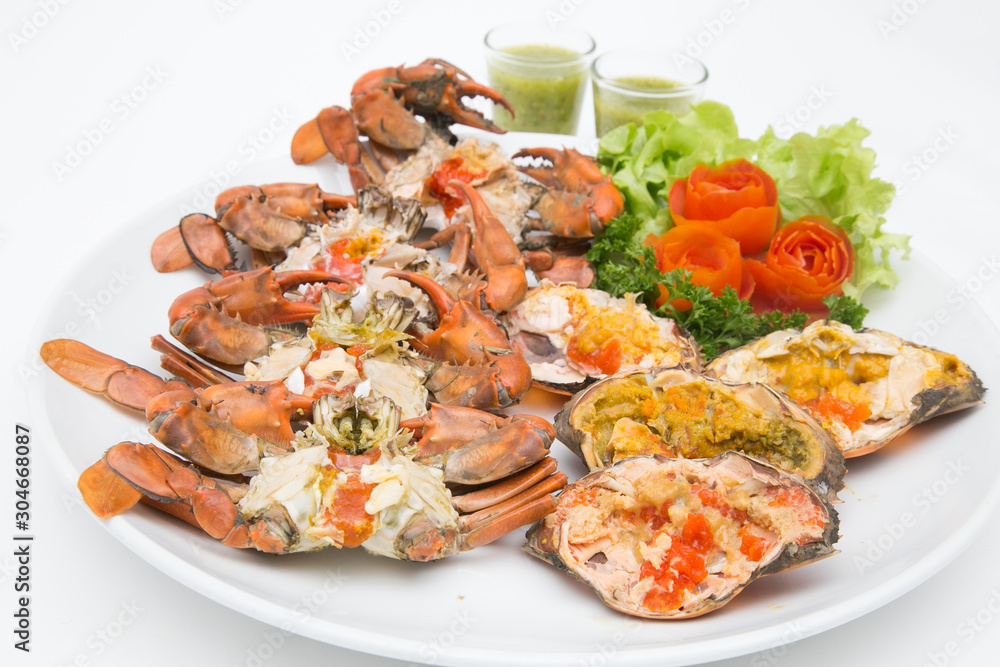 Boiled crab fresh and hot - delicious appetizer Steamed crabs and crab's spawn with seafood spicy sauce Thai seafood, steamed crab showing the delicious crab's eggs inside its shell.