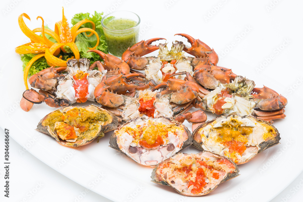 Boiled crab fresh and hot - delicious appetizer Steamed crabs and crab's spawn with seafood spicy sauce Thai seafood, steamed crab showing the delicious crab's eggs inside its shell. Boiled crab fresh and hot - delicious appetizer Steamed crabs and crab's spawn with seafood spicy sauce Thai seafood, steamed crab showing the delicious crab's eggs inside its shell.