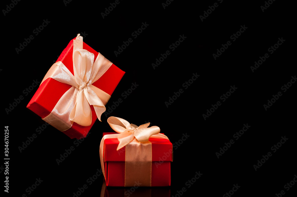 Gift box with white ribbon on black background. zero gravity. levitation. milimalism. Concept sales, shopping, christmas holidays, valentin's day and birthday. Gift box with white ribbon on black background. zero gravity. levitation. milimalism. Concept sales, shopping, christmas holidays, valentin's day and birthday.