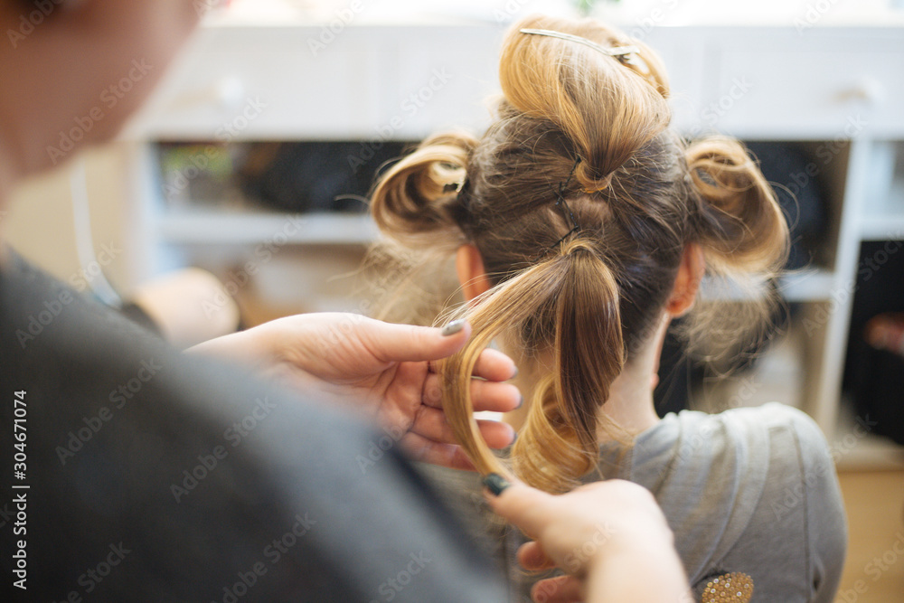 Fototapeta premium Hairdresser does wedding hairstyle for bride.