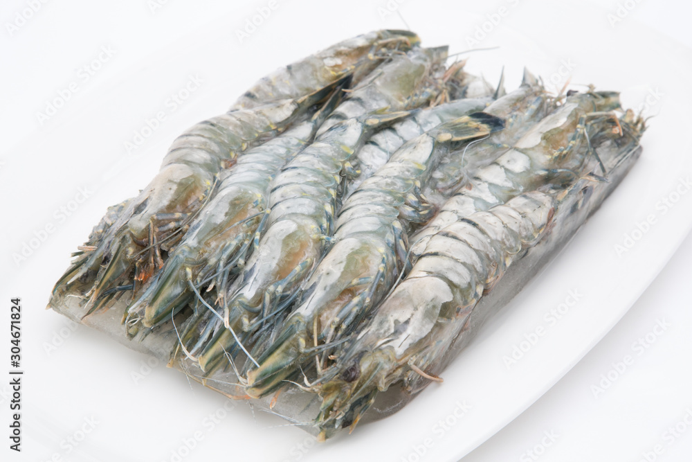 Frozen fresh big shrimps prawns being prepared for seafood cooking on white background Frozen fresh big shrimps prawns being prepared for seafood cooking on white background