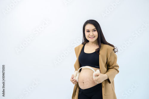 Pregnant women stand away from the white background