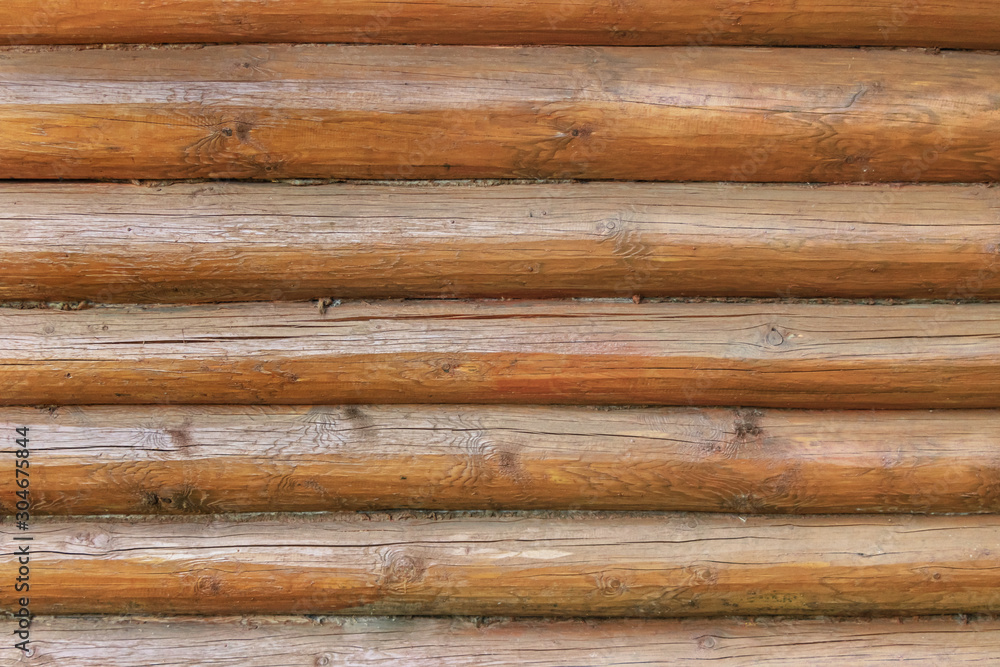 Wall of a house made of horizontal natural wooden logs