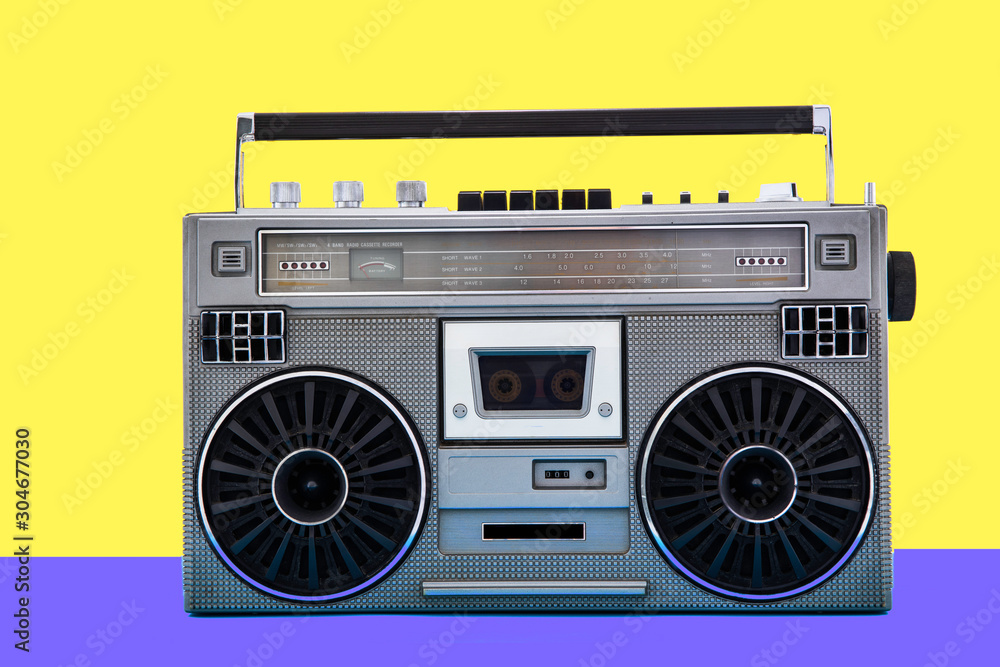 1980s Silver retro radio boom box on color background. Disco music