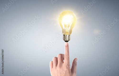 Hand of holding illuminated light bulb, idea, innovation inspiration concept