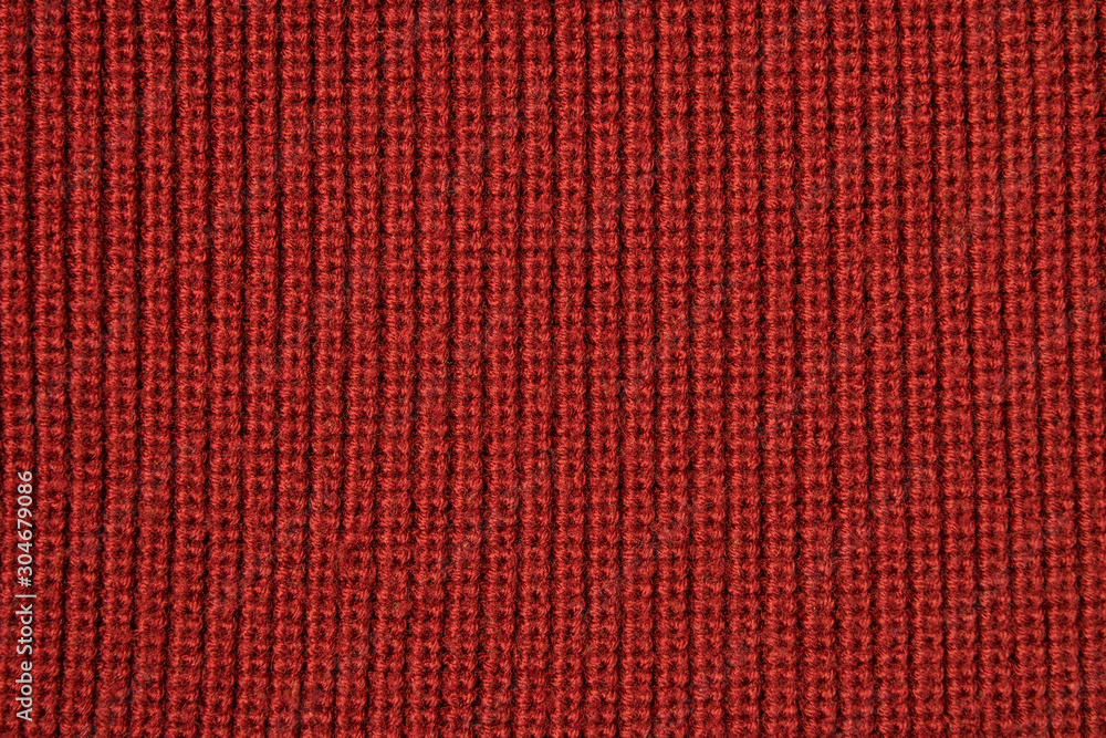 Red background from red knitted wool closeup Red background from red knitted wool closeup