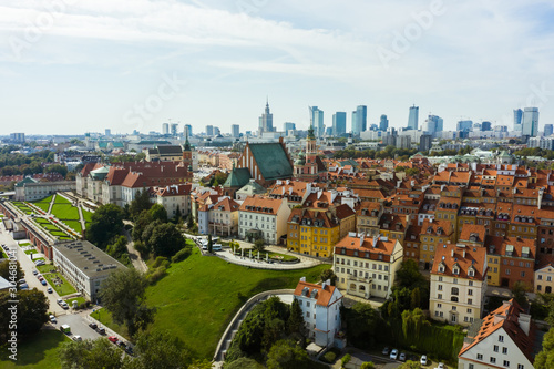 Aerial view of the old city and the royal palace in the historical center of Warsaw, Poland. Drone shot flying over city buildings in the Old Town.