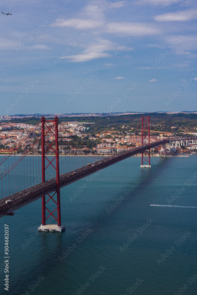 Naklejka premium Ponte 25 de Abril is a suspension bridge connecting the city of Lisbon, to the Almada