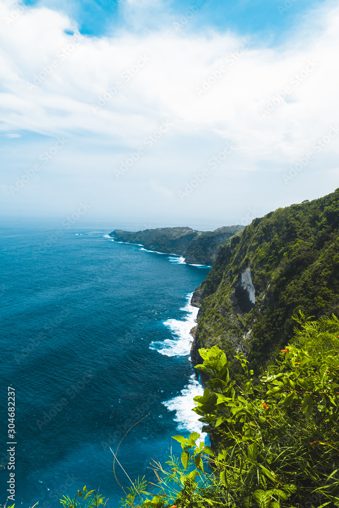 Amazing panoramic view of tropical beach, sea rocks and turquoise ocean, blue sky. Atuh beach, Nusa Penida island, island of Bali, Indonesia. Travel concept. Manta Bay or Kelkinkin Beach