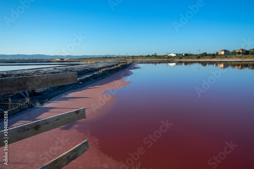 Landscape in pink and blue. Salt mines and the path between them. With reflection. Burgas, Bulgaria.