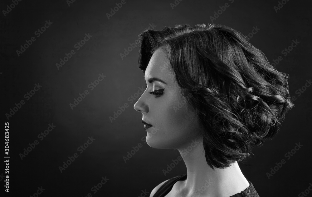 Beautiful brunette with perfect hairstyle and professional  make-up. Black and white.