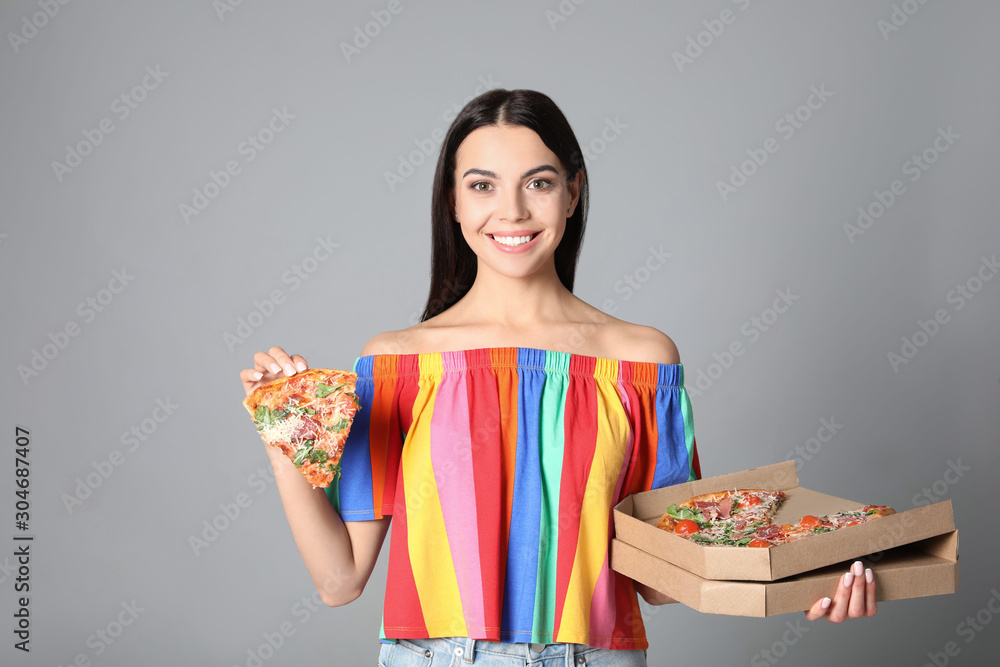 Beautiful woman with pizza on grey background Beautiful woman with pizza on grey background
