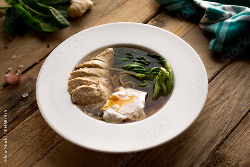 chicken soup with poached egg and spinach