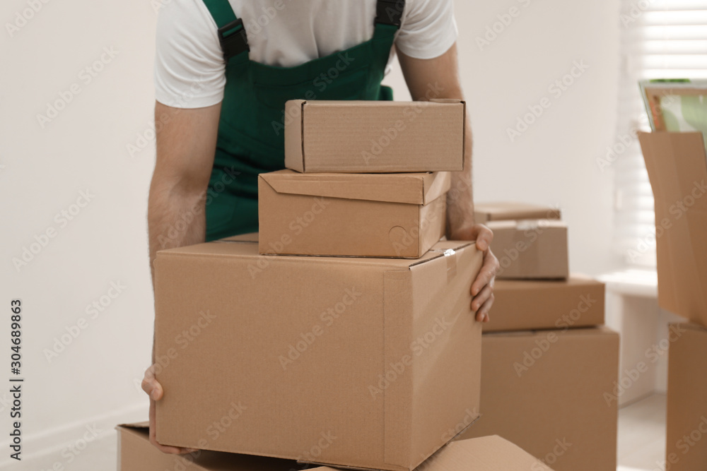 Man with cardboard boxes in room, closeup. Moving service Man with cardboard boxes in room, closeup. Moving service