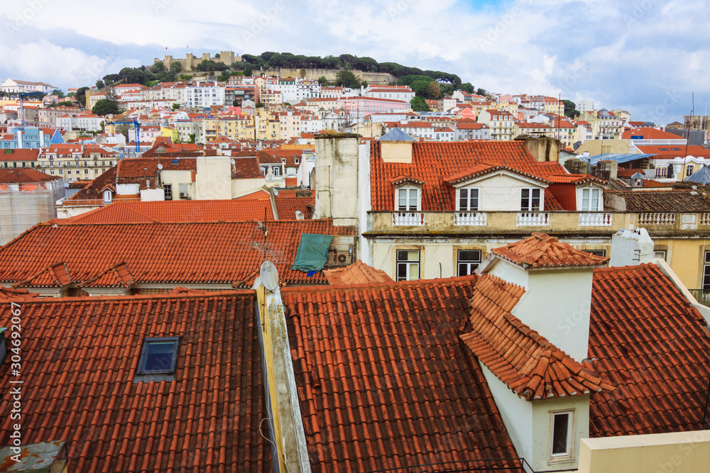 Lisbon, Portugal - May, 24th, 2018 : Baixa downtown roofs overview towards Sao Jorge Castle as seen from the Santa Justa elevator.