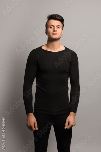 Man wearing thermal underwear on grey background © New Africa