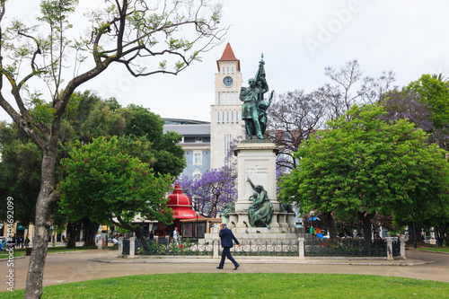 Lisbon, Portugal - May, 29th, 2018 : A man walks past the Marquês de Sá da Bandeira statue at D. Luis square in Cais do Sodre neighborhood. photo