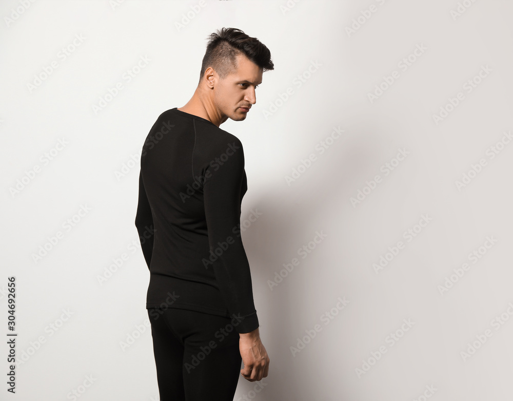 Man wearing thermal underwear on light grey background. Space for text Man wearing thermal underwear on light grey background. Space for text