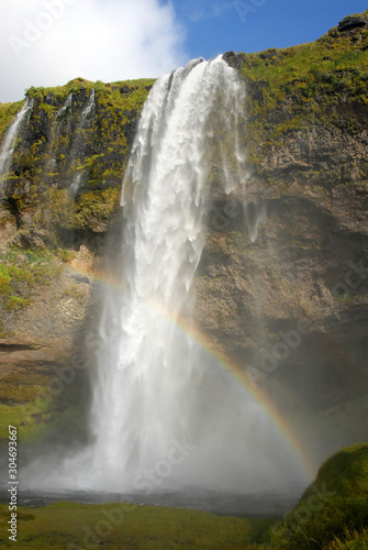 Seljalandsfoss Waterfall in Iceland. A famous waterfall with a path to walk behind the falls.