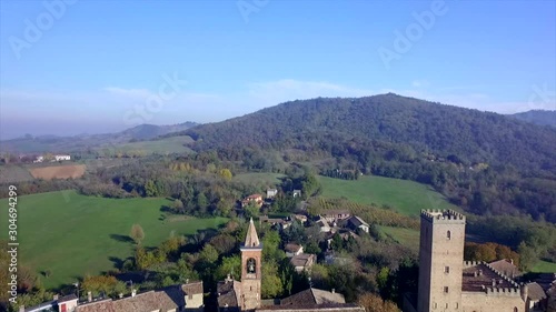 4k backward aerial drone footage to the old village of Rivanazzano in Oltrepò Pavese countryside near Pavia. photo