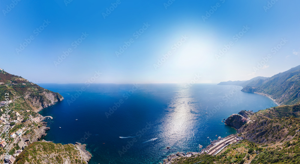 Aerial view from distance, general view of the area Manarola and Riomaggiore - Villages of National Park. Province of La Spezia, Liguria, Beautiful mountain north of Italy. Copy space background.