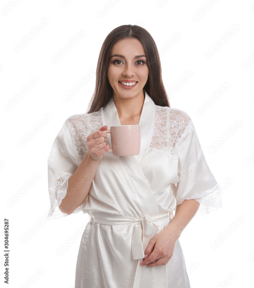 Young woman in silk robe with cup of beverage on white background Young woman in silk robe with cup of beverage on white background