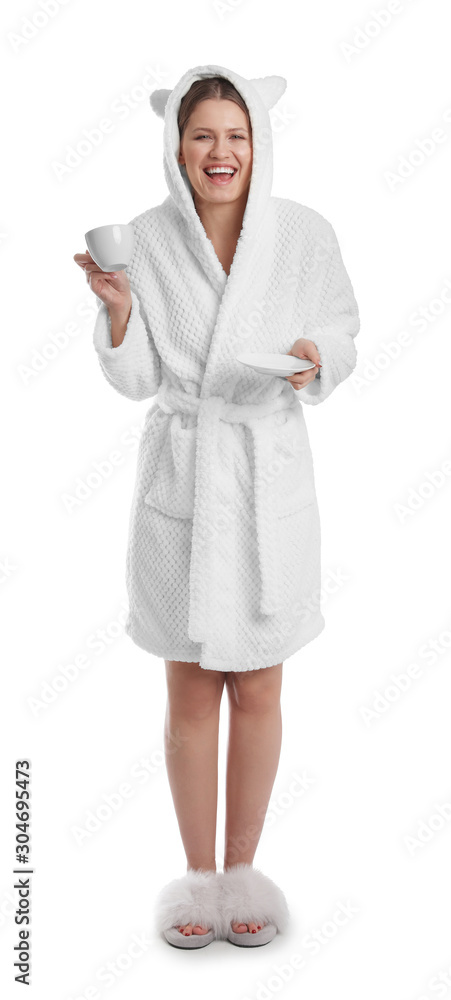 Young woman in bathrobe with cup of beverage on white background Young woman in bathrobe with cup of beverage on white background