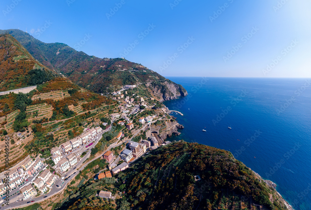 Aerial view from distance, general view of the area Riomaggiore. bridge, rocky beach, paradise on earth Province of La Spezia, Liguria, Beautiful mountain north of Italy. Copy space background.