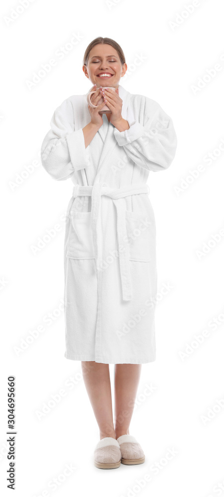 Young woman in bathrobe with cup of beverage on white background Young woman in bathrobe with cup of beverage on white background