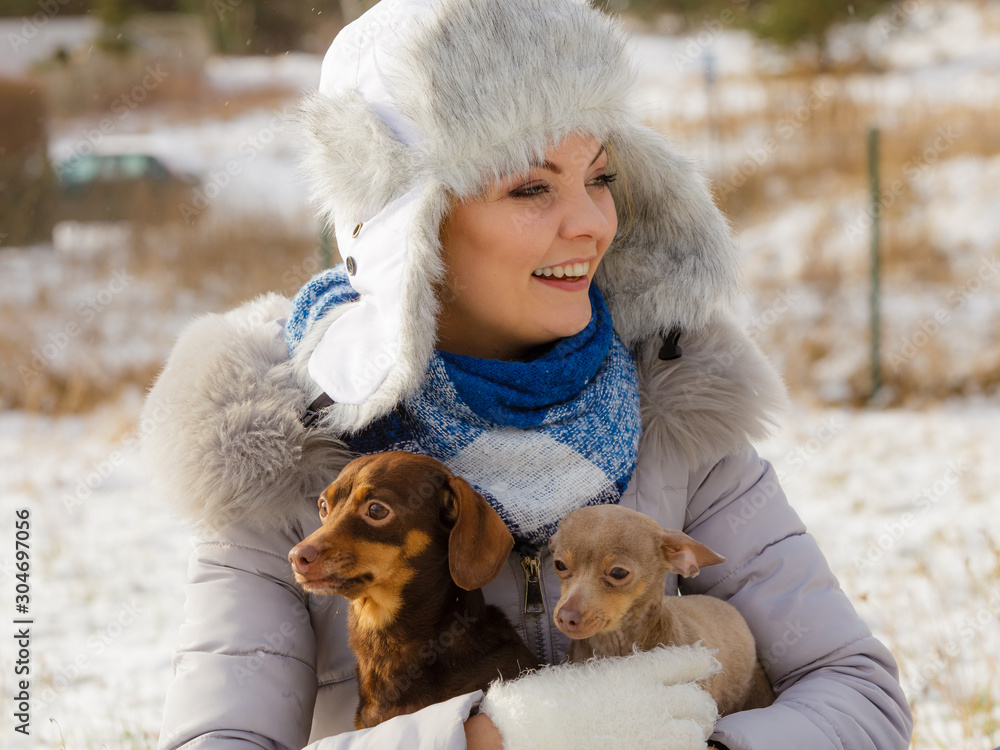 Woman playing with dogs during winter Woman playing with dogs during winter