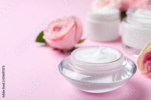 Jar of organic cream on pink background. Space for text