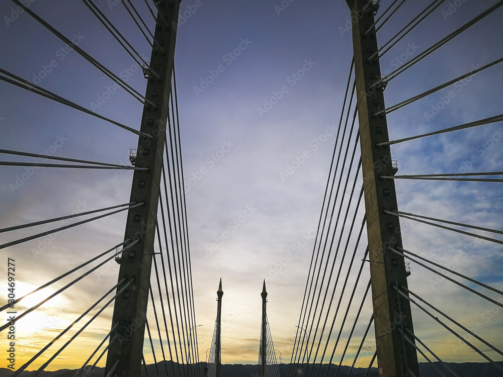 Fototapeta premium Towers of Bridge connecting George Town on Penang island and Seberang Prai on mainland of Malaysia through straits of Malacca.