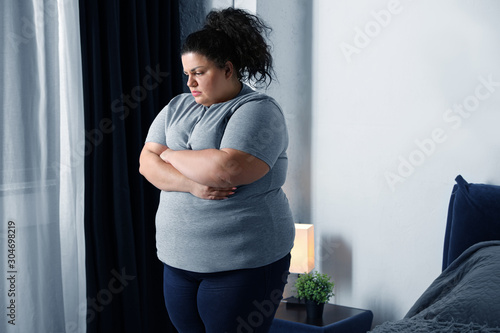 Cuadro en lienzo Overweight woman suffering from depression at home