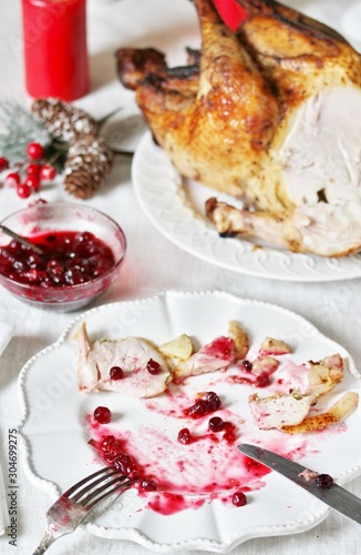 dirty dishes in the Christmas after eating turkey with cranberry sauce. leftover food after the holiday.dirty dishes after christmas. holiday leftovers