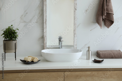 Modern bathroom interior with stylish mirror and vessel sink