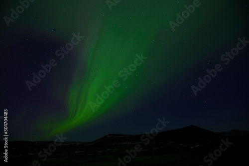 Mixed colorful aurora borealis dancing in the sky © Tazzjang