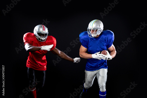 Two American football players in action