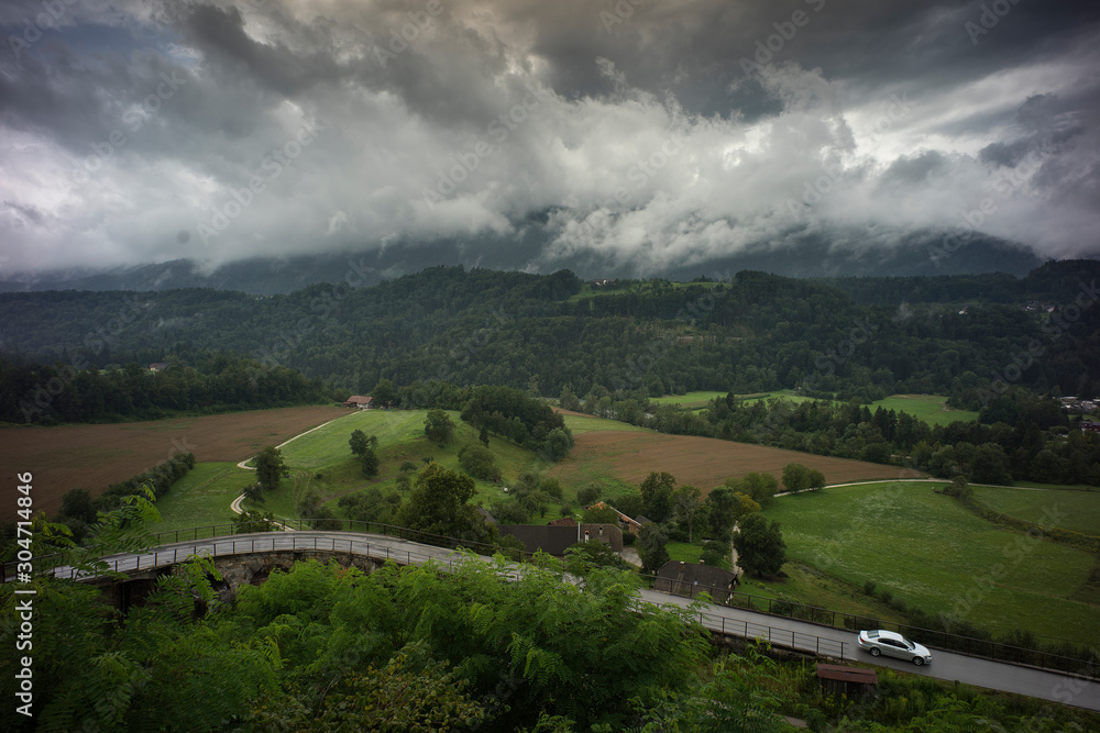 Car driving on a road in a beautiful mountain landscape Car driving on a road in a beautiful mountain landscape