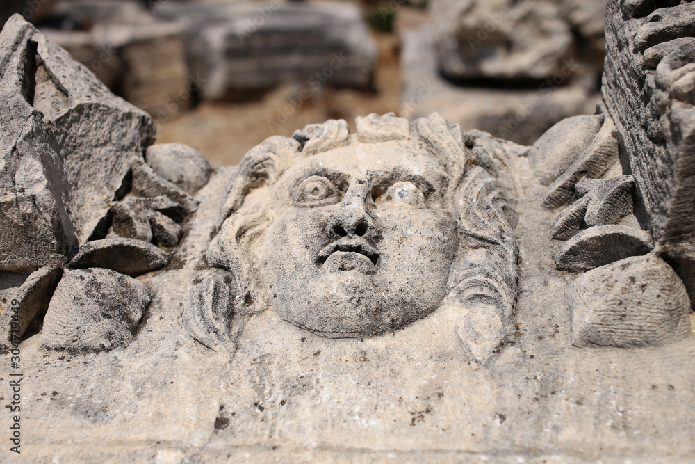 Ancient Roman image of a female portrait on a stone of ancient architecture.