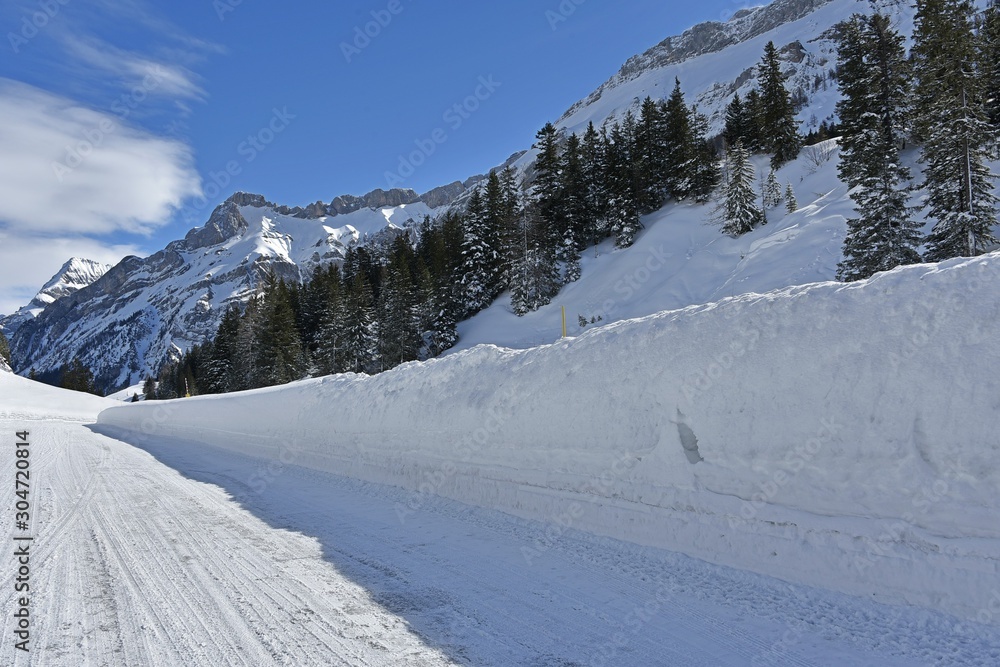 winter mountain road and snow walls