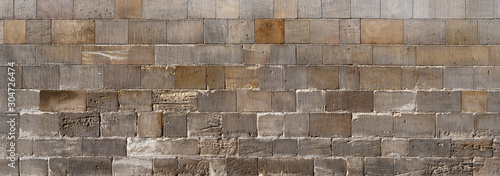 Panorama Kirchenmauer - Sehr alte, grau braune Mauer aus eckigen Steinen photo