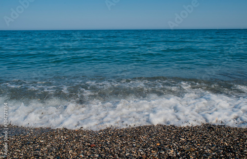 waves breaks when you reach the sand with strength and white foam