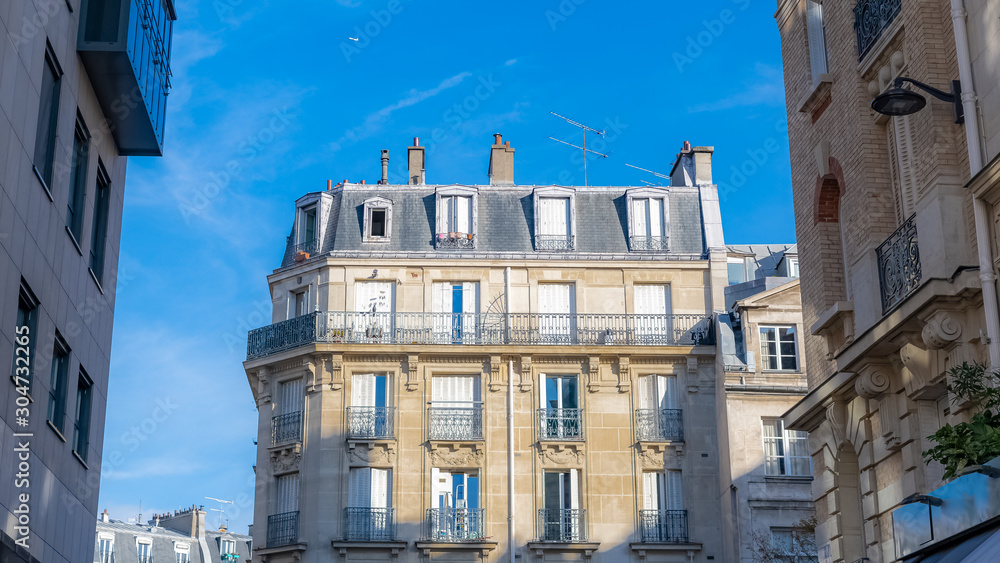 Paris, ancient and modern buildings in the center, typical parisian facade and windows, rue Montmartre
