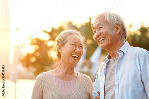 outdoor portrait of happy senior asian couple photo