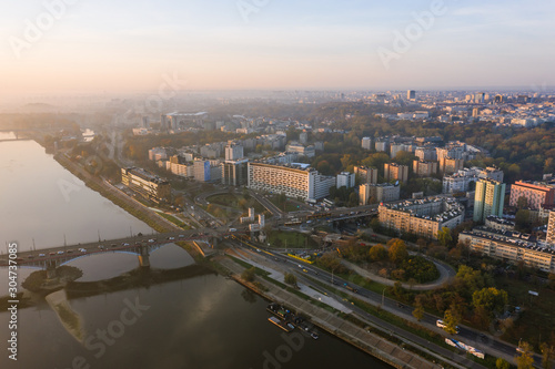 Warsaw, Poland. 26. October. 2019.  Cityscape with skyscrapers and knowledge and roads at sunrise.  Aerial view of the river and the city with skyscrapers and buildings in the early morning. © Oleksandr